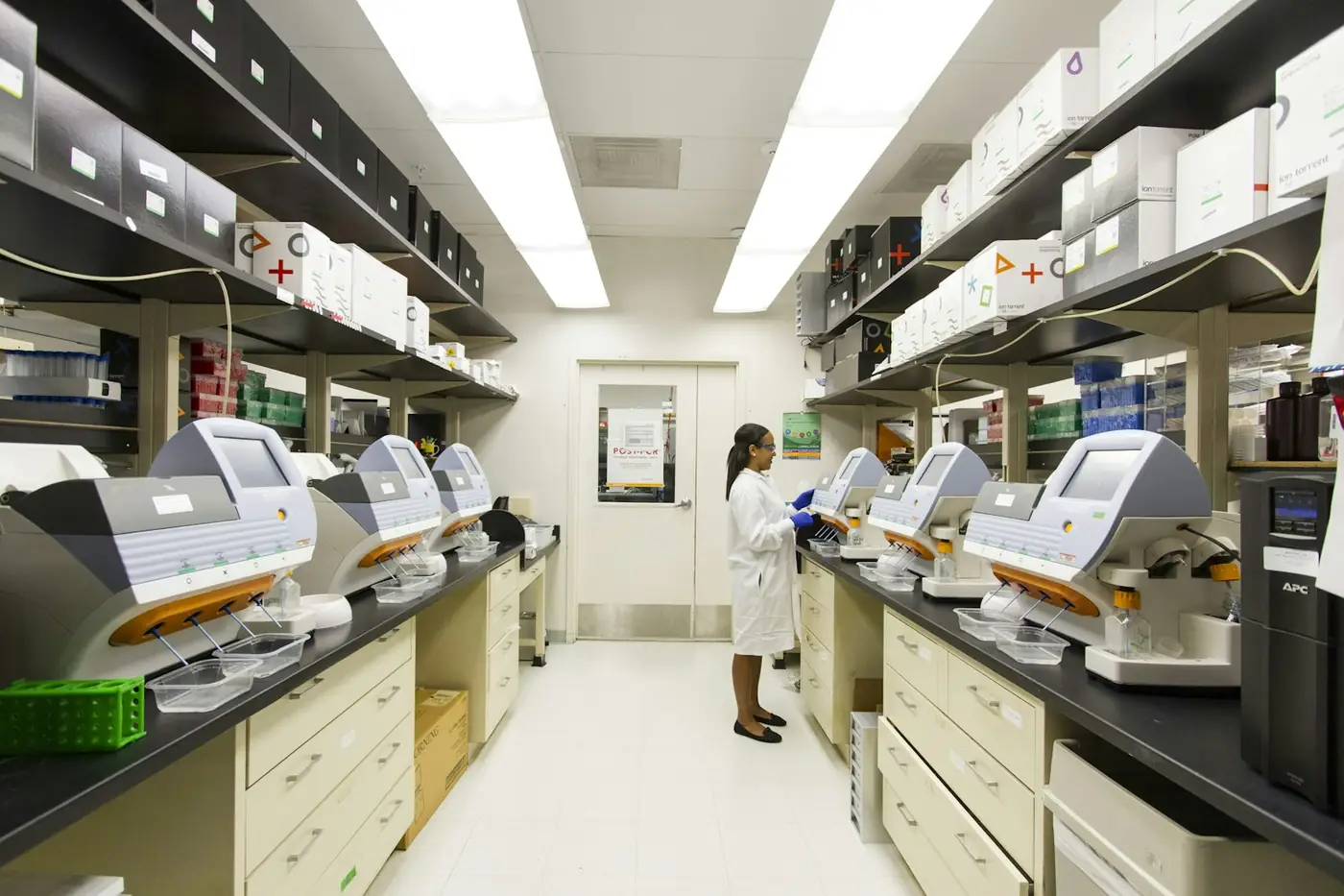 Modern biotech laboratory with rows of sequencing equipment